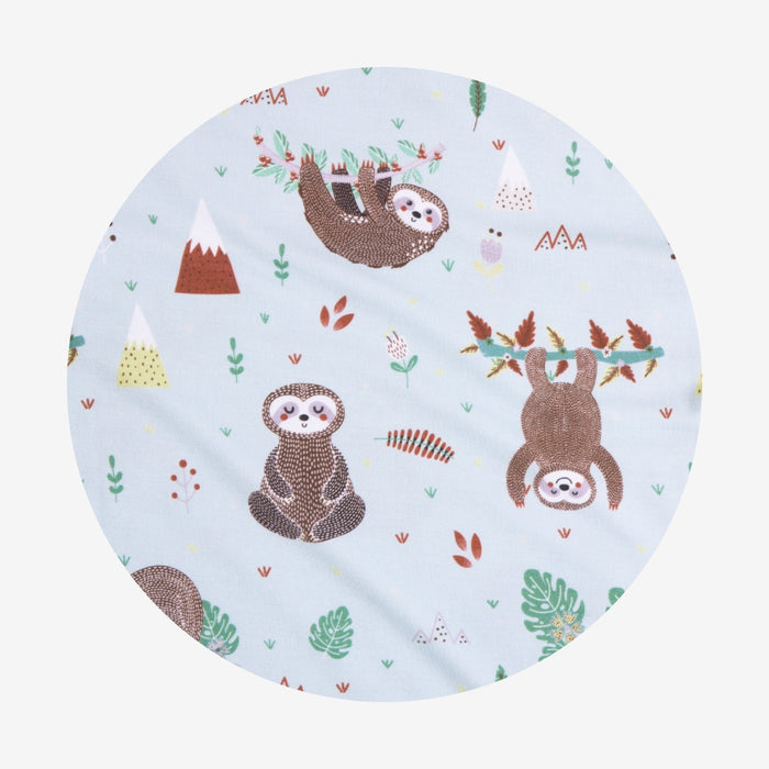 Round fabric swatch with sloth pattern on a light blue background