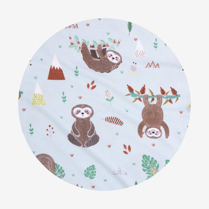 Round fabric swatch with sloth pattern on a light blue background