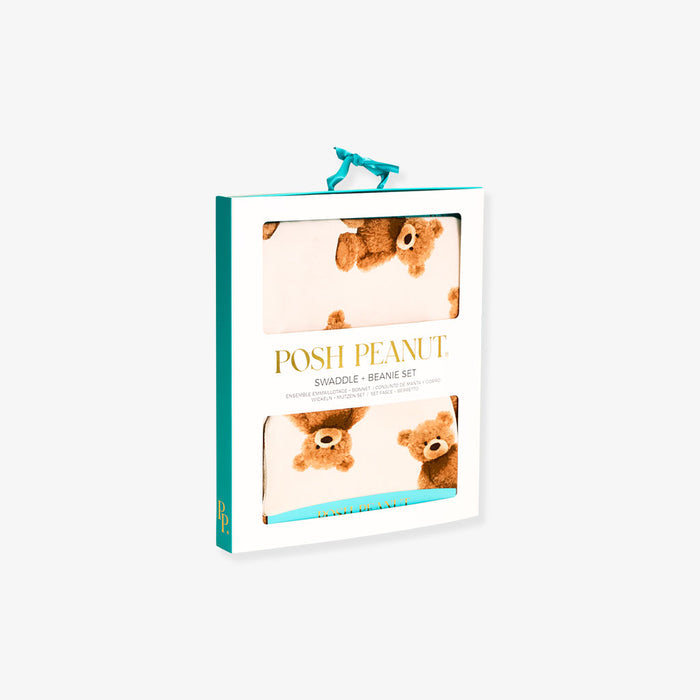 Packaged swaddle and beanie set with 'Posh Peanut' branding on a white background