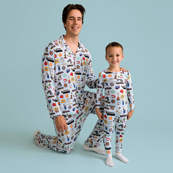 Man and child wearing matching pajamas with a pattern on a light blue background