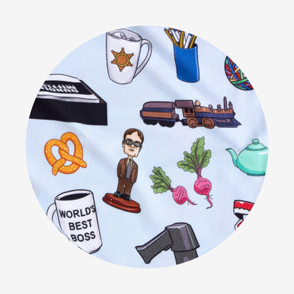 Circular fabric closeup with various illustrations from The Office television show including a person, coffee cup, train, and pretzel on a light blue background.